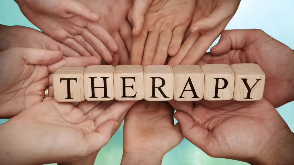 Lots of hands holding a sign made of wooden blocks. The sign says therapy. The picture is for the article titled what is therapy